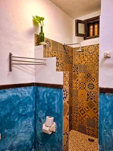 a bathroom with a shower with a toilet in it at Beachfront Hacienda del Cuyo Groundfloor in El Cuyo