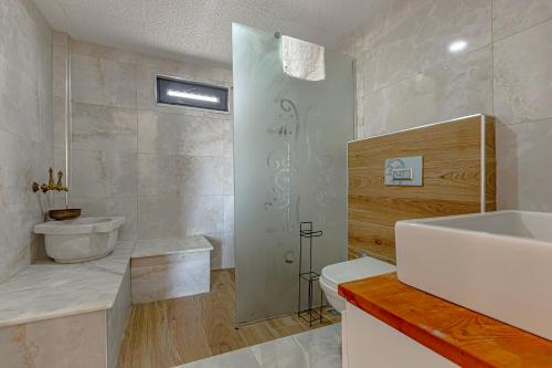 a bathroom with a sink and a toilet and a shower at Casa Rosa Luxury Villa w heated Pool in Belek