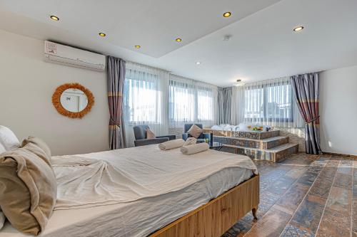 a bedroom with a large bed and a living room at Casa Rosa Luxury Villa w heated Pool in Belek