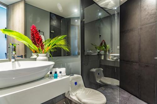 a bathroom with a white sink and a toilet at Bonita Bay Concept Hotel by Xarm Hotels in Santa Marta