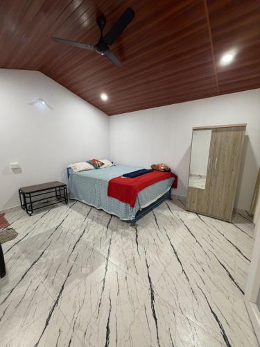 a bedroom with a bed and a wooden ceiling at SHIV SAI HUTS in Canacona