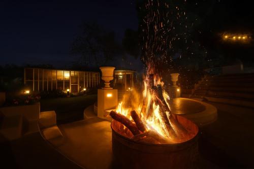 a fire pit in a yard at night at JC Residency in Kodaikānāl