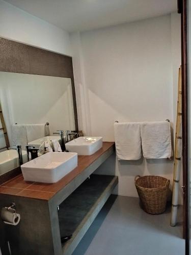 a bathroom with two sinks and a large mirror at VILLA JADE orchid life residence in Koh Samui