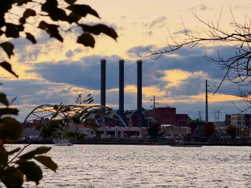 a view of a factory from the water at Cozy 2BR Apt with Parking, Steps to Brown and RISD in Providence