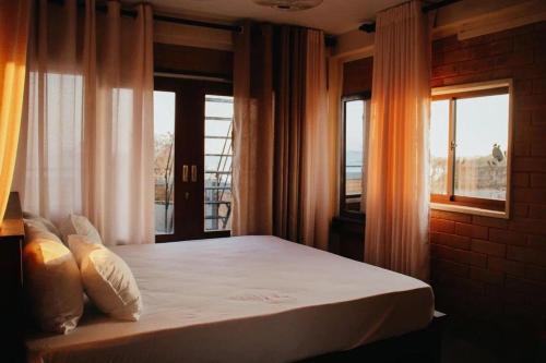 a bedroom with a large bed with a window at Florance Nice Hotel Weligama in Weligama
