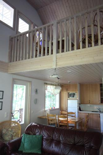 a living room and kitchen with a loft at Strandkulla in Svalskulla