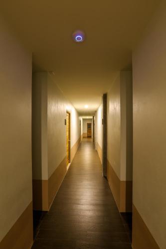 an empty hallway with a purple light on the ceiling at Living Chilled Koh Tao in Koh Tao