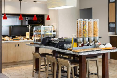 a kitchen with a large table with chairs at Hilton Garden Inn Memphis/Wolfchase Galleria in Memphis