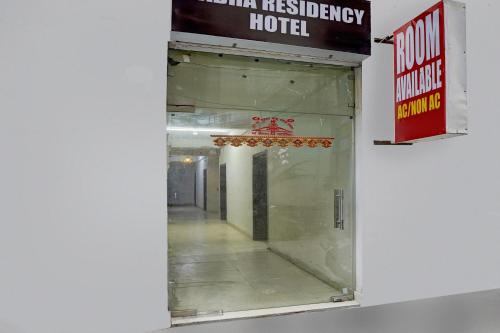 a mirror on the wall of a hotel at Hotel O Radha Residency in Badarpur