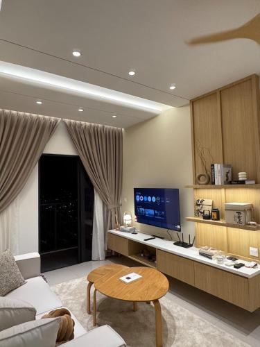 a living room with a couch and a tv at M Luna Residence in Kuala Lumpur