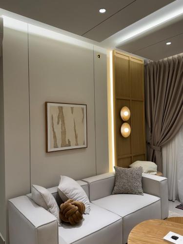 a living room with a white couch and a table at M Luna Residence in Kuala Lumpur