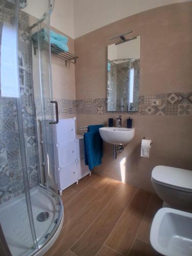 a bathroom with a shower and a sink and a toilet at Posidonia in Lizzano