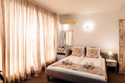 a bedroom with a bed with two towels on it at Hotel Kiev in Veliko Tŭrnovo