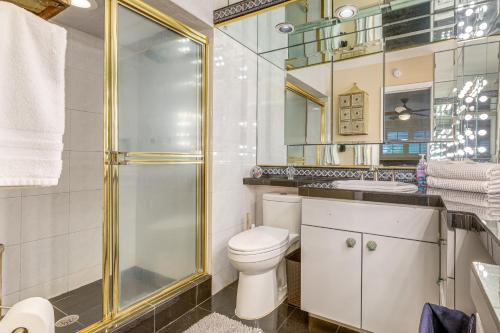 a bathroom with a toilet and a shower and a sink at Family Fishing Trip! Jupiter Home with Dock, Hot Tub in Jupiter