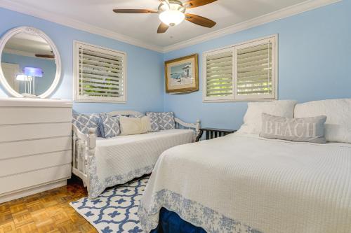a blue bedroom with two beds and a window at Family Fishing Trip! Jupiter Home with Dock, Hot Tub in Jupiter