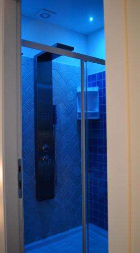 a bathroom with a shower with blue tiles at B&B Harmonia in SantʼElpidio a Mare