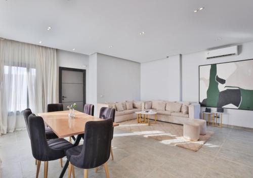 a living room with a table and a couch at The Green Escape 4BR Villa By Travelholic in Cairo