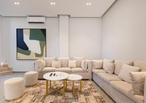 a living room with a couch and a table at The Green Escape 4BR Villa By Travelholic in Cairo