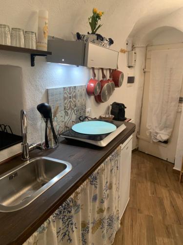 a kitchen with a sink and a counter top at Casa Delfino in Sanremo