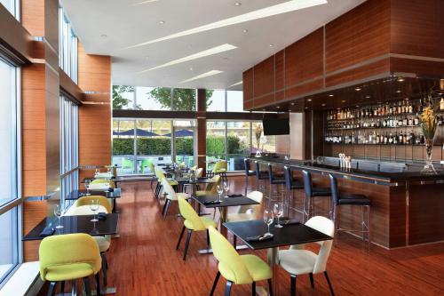 a restaurant with tables and chairs and a bar at The Westin Wall Centre, Vancouver Airport in Richmond