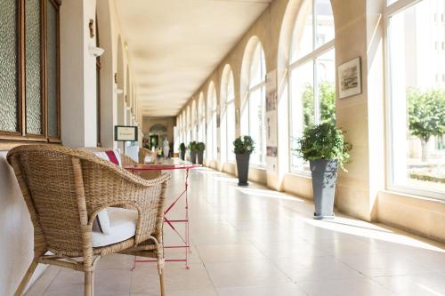 a hallway with chairs and tables in a building at Hostellerie Bon Pasteur in Angers