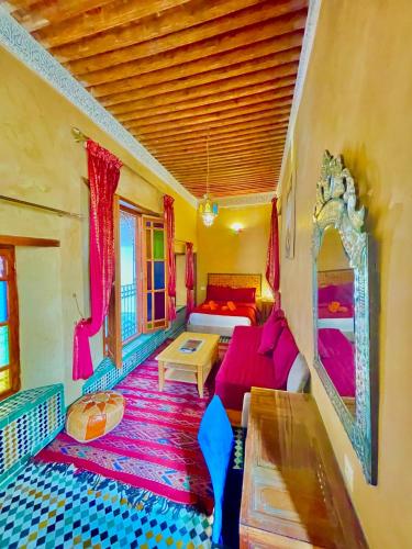 a living room with a couch and a table at RIAD LALJ Fes in Fez