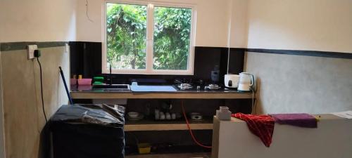 a room with a desk with a window in it at Holiday Home Ragama in Ragama
