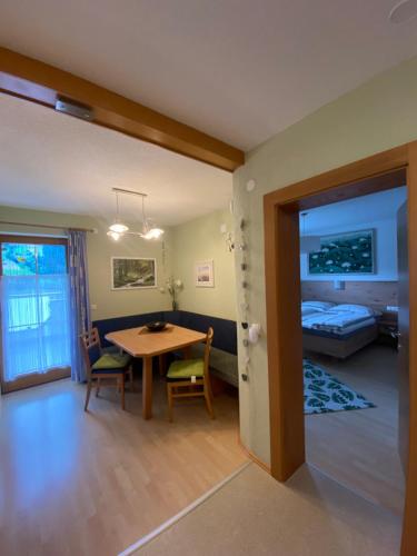 a living room with a table and a bedroom at Ferienhaus Dengg in Hippach