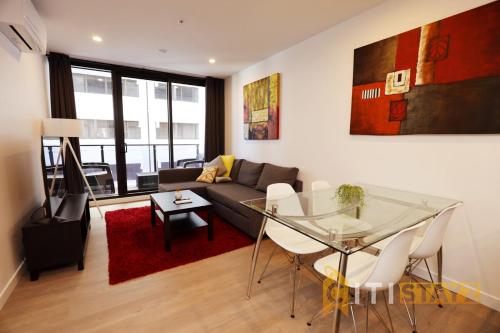 a living room with a glass table and a couch at Red Rose Retreat - 1bd 1bth 1CarSp Apt in Lyons