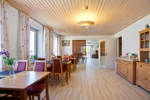 a dining room with wooden tables and chairs at Thorup Strands Gæstgiveri in Knebel