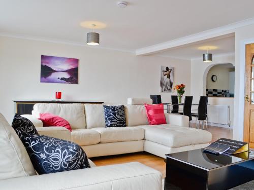 a living room with a couch and a table at Seaview in Oban