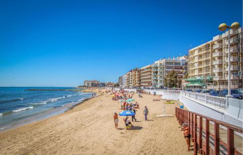 a group of people on a beach near the ocean at Awesome Apartment In Torrevieja With Wifi in Torrevieja