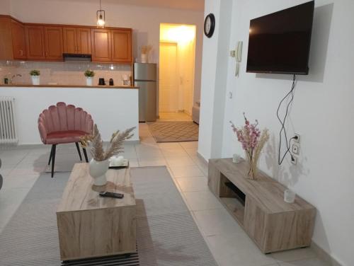 a living room with a television on a wall at Misty Place in Ioannina