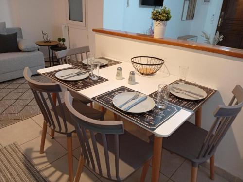 a dining room table with plates and glasses on it at Misty Place in Ioannina
