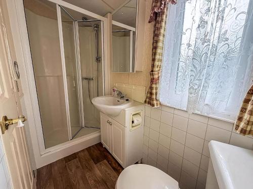 a bathroom with a toilet and a sink and a shower at Great 6 Berth Caravan, Perfect For A Beach Holiday In Hunstanton Ref 13007L in Hunstanton