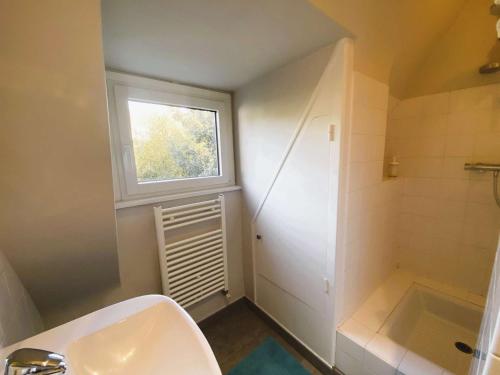 a bathroom with a sink and a window at Maison 5 chambres à 150 m de la plage, rénovée, jardin, proche restaurants et commerces - FR-1-481-161 in Bénodet