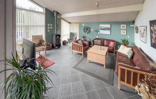 a living room with a couch and a table at Cozy Home In Tarm With Sauna in Højsand