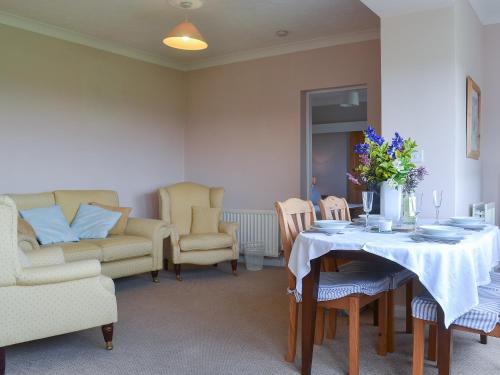 a dining room with a table and chairs at Jasmine Cottage in Knitsley