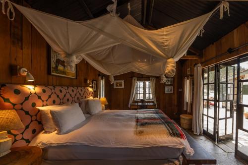 a bedroom with a large bed with a canopy at Rose Cottage Romantic Cottage In Wildlife in Naivasha