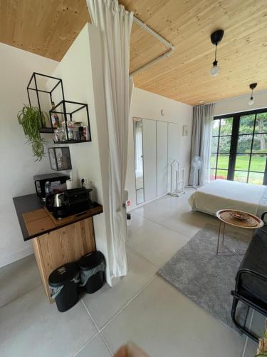 a bedroom with a bed and a table in a room at de graslelie in Schoten