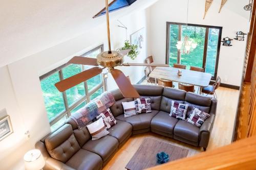 a living room with a couch and a ceiling fan at Blue Haven home in Killington Village
