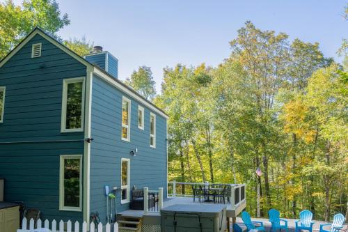 a blue house with a deck and chairs at Blue Haven home in Killington Village