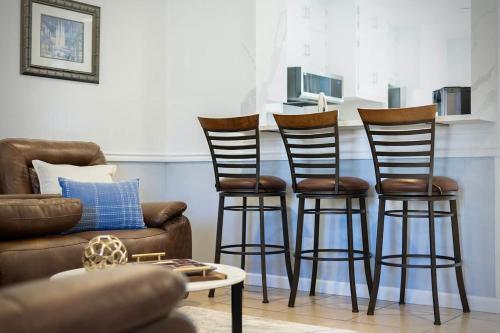 a living room with three bar stools and a couch at NEW Medical Professional Home Near Scott & White Medical and McClains Children Hospital in Temple