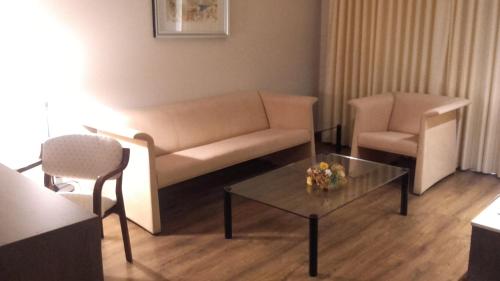 a living room with a couch and a table and chairs at Balneario de Ledesma in Vega de Tirados