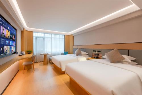 Postel nebo postele na pokoji v ubytování Foshan Shunde Beijiao Zhongyue International Hotel
