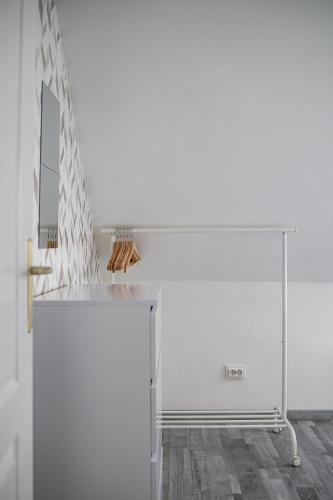 a room with a white wall and a mirror at Venus Apartments - Mira Nest in Budapest