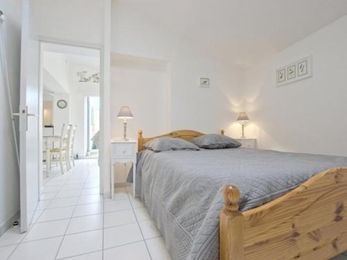 a white bedroom with a bed and a white tile floor at Appartement avec terrasse au port d'Ars-en-Ré, Wi-Fi gratuit - FR-1-835-6 in Ars-en-Ré