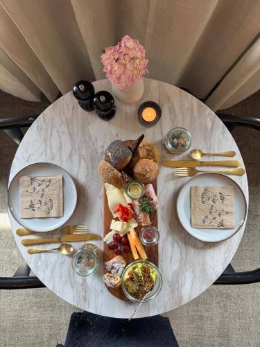 a table topped with plates of food on top at Hotel Arnkilhus in Sønderborg