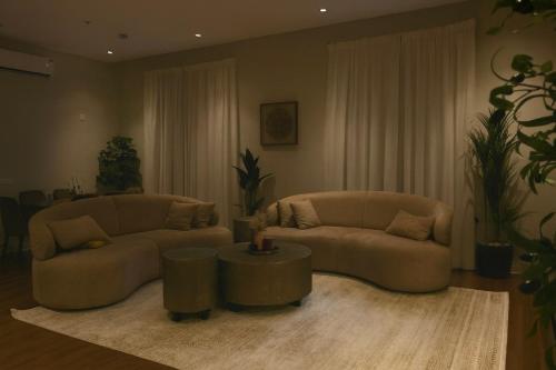 een woonkamer met twee banken en een tafel bij luxury apartment AL Majdiah Residence K,Hittin,Boulevard, البوليفارد in Riyad