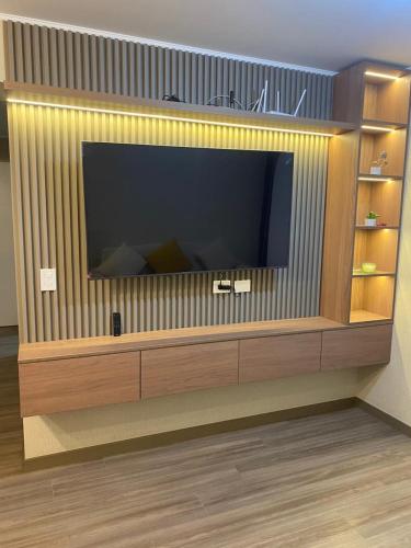 a large entertainment center with a large flat screen tv at La Foret in Lima